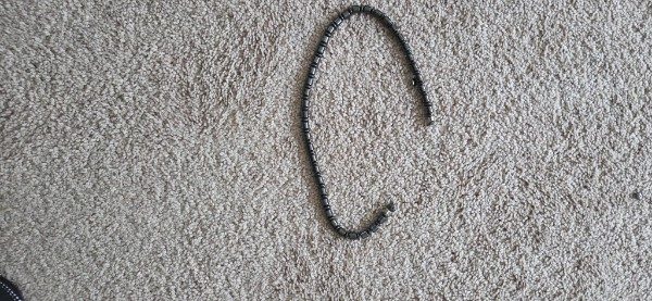 Necklace on carpet, phone photo 1
