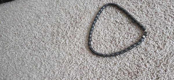 Necklace on carpet, phone photo 2