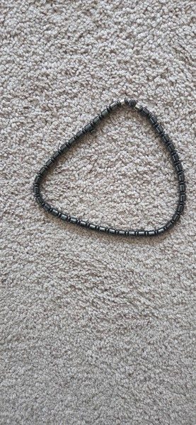 Necklace on carpet, phone photo 3
